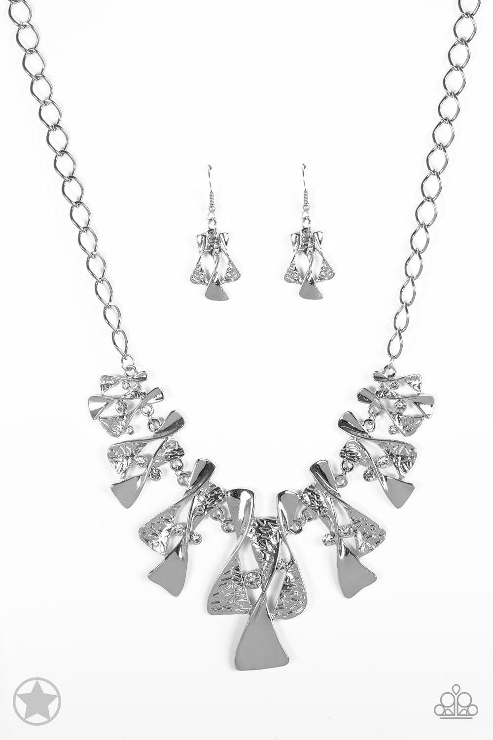 Paparazzi Accessories The Sands Of Time - Silver Twisted silver hourglasses dance along a chunky silver chain with tiny clear rhinestones adding sparkling, elegant accents. Beautiful textured pieces add depth to the design. Features an adjustable clasp cl