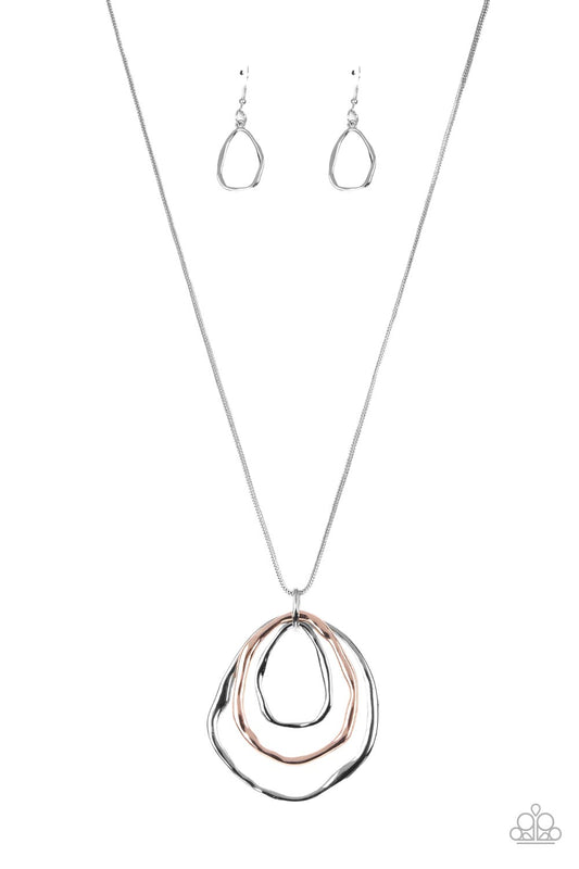 Paparazzi Accessories Revamped Relic - Silver A trio of mismatched warped rose gold and silver rings swing from the bottom of a glistening silver chain, creating an asymmetrically stacked pendant. Features an adjustable clasp closure. Necklaces