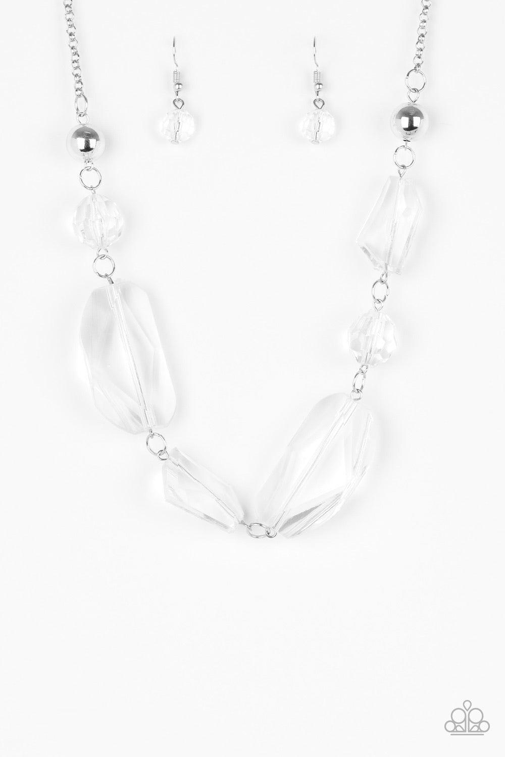 Paparazzi Accessories Luminous Luminary - White A dainty white rhinestone encrusted heart frame swings from the top of an oversized silver heart frame, creating a charming duo. Earring attaches to a standard fishhook fitting. Jewelry