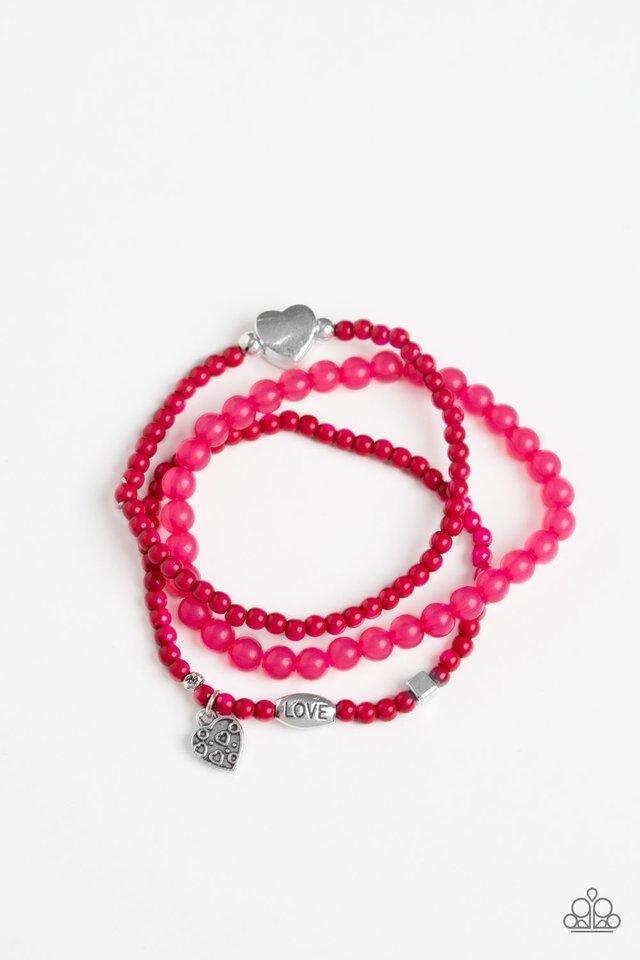 Paparazzi Accessories Really Romantic - Pink An array of glassy and polished pink beads are threaded along stretchy bands. Infused with silver accents, a collection of silver heart charms and a bead spelling out the word, "love", adorn the beaded strands