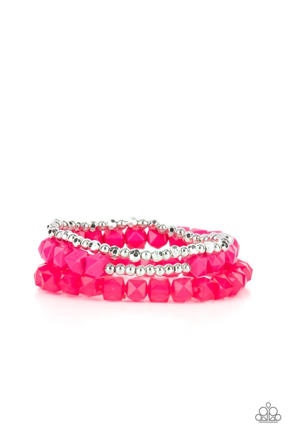 Paparazzi Accessories Vacay Vegabond - Pink Infused with a strand of round and faceted silver beads, faceted rows of solid and opaque pink cube beads are threaded along stretchy bands, wrapping around the wrist for a vivacious pop of color. Sold as one se