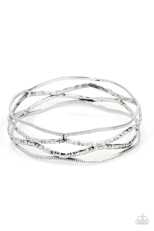 Paparazzi Accessories A Narrow ESCAPADE - Silver Textured and embossed in nature inspired patterns, rustic silver bars zigzag around the wrist as they stack into a wildly layered bangle. Sold as one individual bracelet. Jewelry