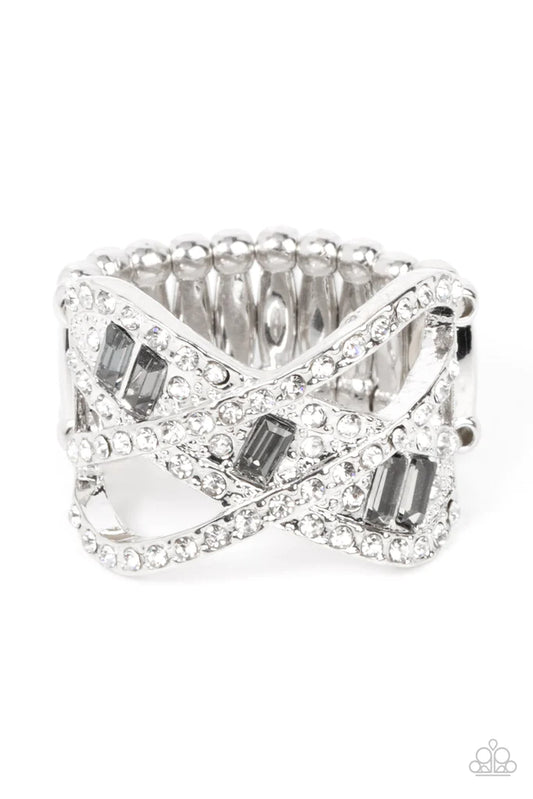 Paparazzi Accessories Triple Threat Twinkle - Silver A pair of dainty white rhinestone encrusted silver bands delicately overlap a sparkly frame radiating with round white and emerald cut smoky rhinestones, resulting into a blinding centerpiece. Features
