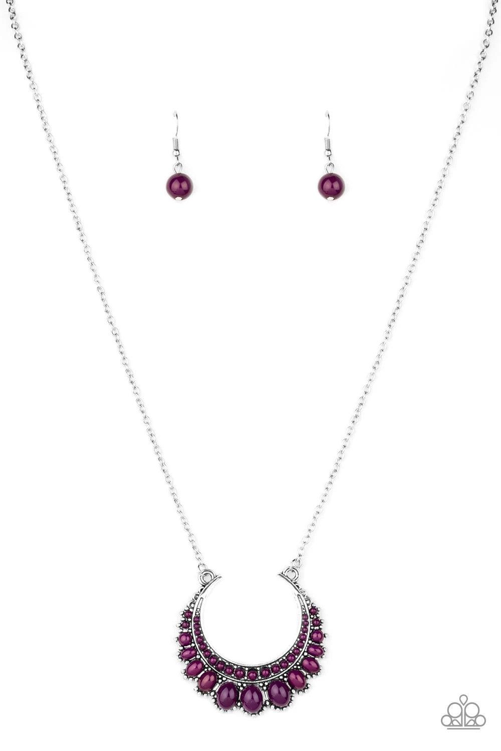 Paparazzi Accessories Count To Zen A- Purple Gradually increasing in size towards the center, dainty purple beads are encrusted along the center of a silver crescent frame. Purple beads flare out from the bottom of the shimmery silver frame, creating a bo