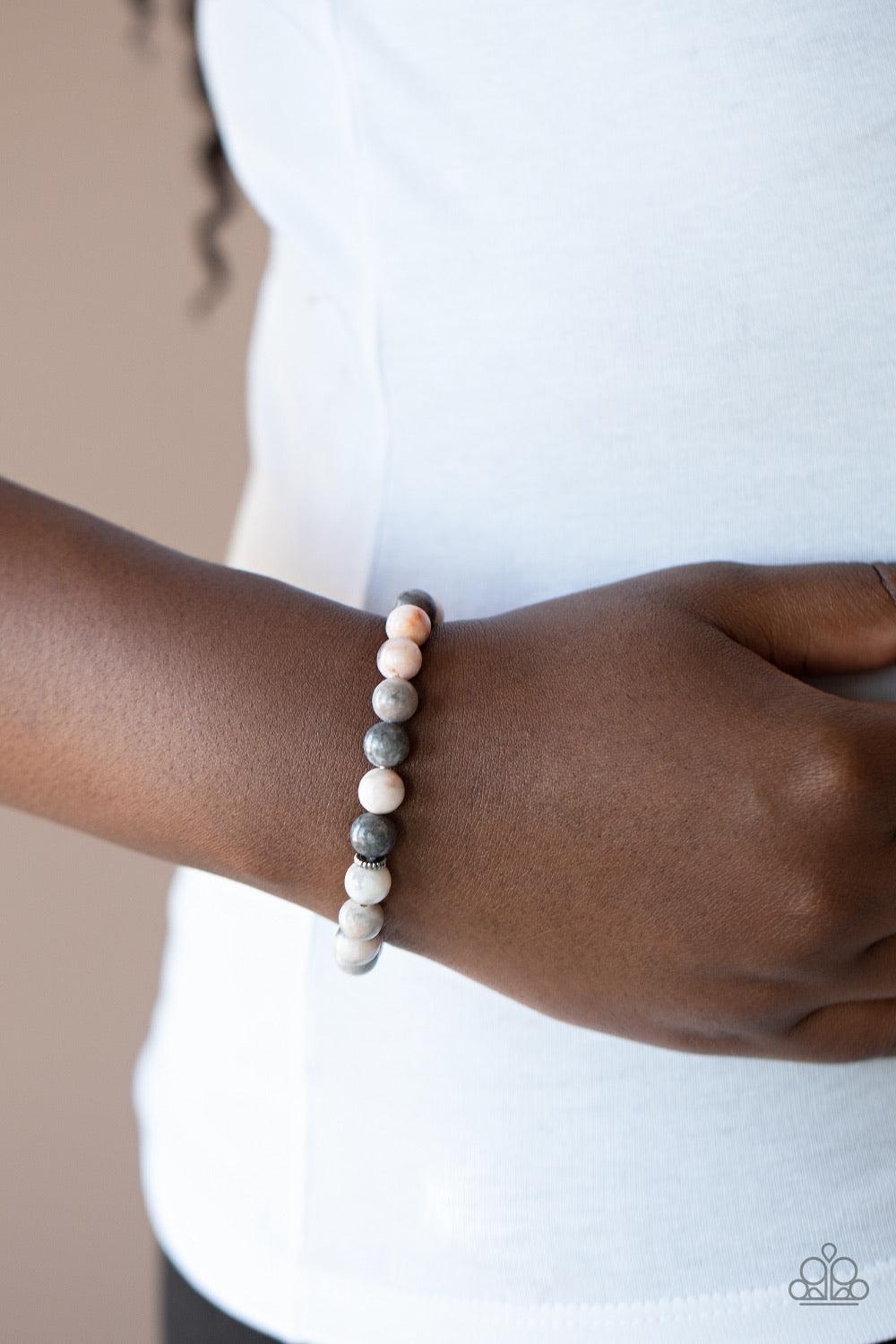 Paparazzi Accessories Invigorated - Pink Infused with dainty silver beads, a collection of refreshing pink, gray, and white stones are threaded along a stretchy band around the wrist for an earthy flair. As the stone elements in this piece are natural, so