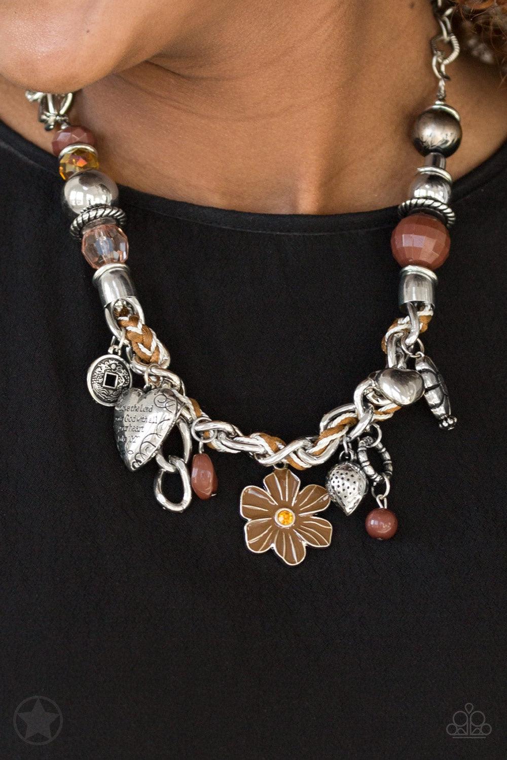 Paparazzi Accessories Charmed, I Am Sure - Brown Brown and ivory cording is braided through a chunky silver chain. A unique variety of charms decorate the piece including a delicate flower and a heart inscribed with the phrase "With All My Heart" on one s