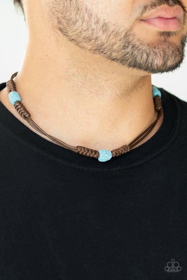Paparazzi Accessories Volcanic Vagabond - Blue Featuring a refreshing blue finish, pumice-like rock beads are knotted in place along stands of shiny brown cords that braid around the neck for a tropical inspired look. Features a button loop closure. Jewel