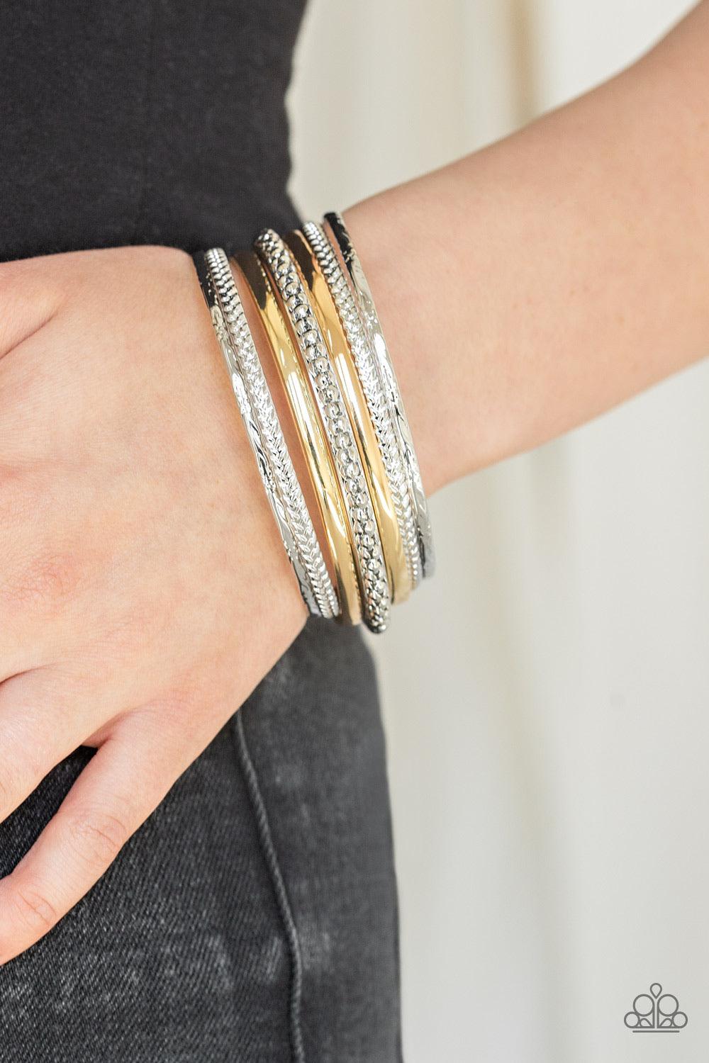 Paparazzi Accessories Hit The Stack - Silver Varying in texture and width, a collision of silver, and gold bangles slide up and down the wrist for a bold, industrial look. Jewelry