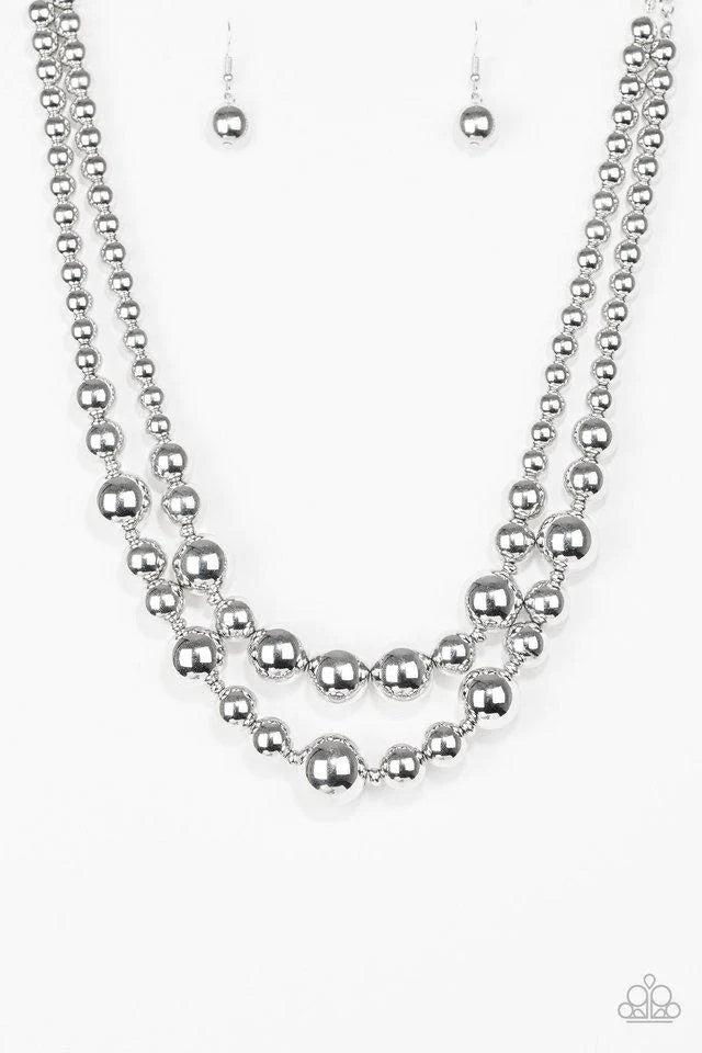 Paparazzi Accessories I Double Dare You - Silver Gradually increasing in size near the center, strands of glistening silver beads are threaded along invisible wires below the collar for a daring look. Features an adjustable clasp closure. Sold as one indi