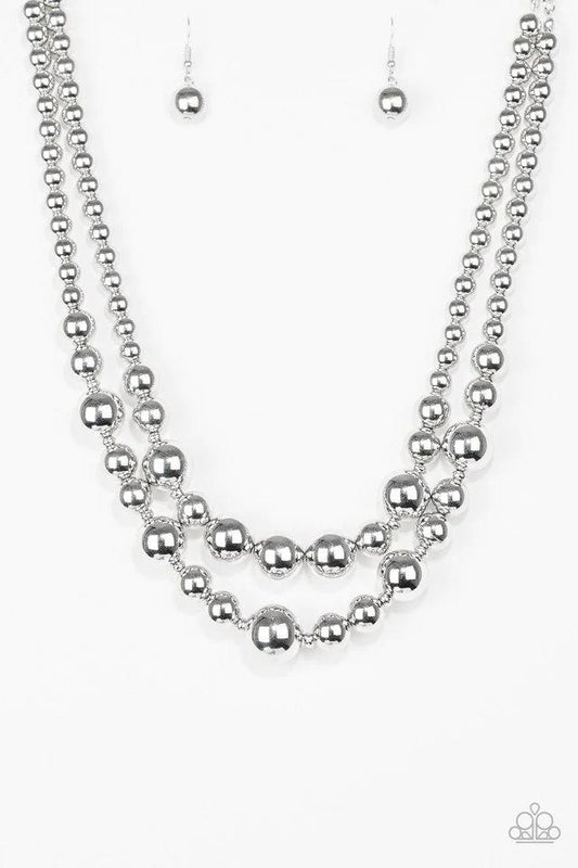 Paparazzi Accessories I Double Dare You - Silver Gradually increasing in size near the center, strands of glistening silver beads are threaded along invisible wires below the collar for a daring look. Features an adjustable clasp closure. Sold as one indi