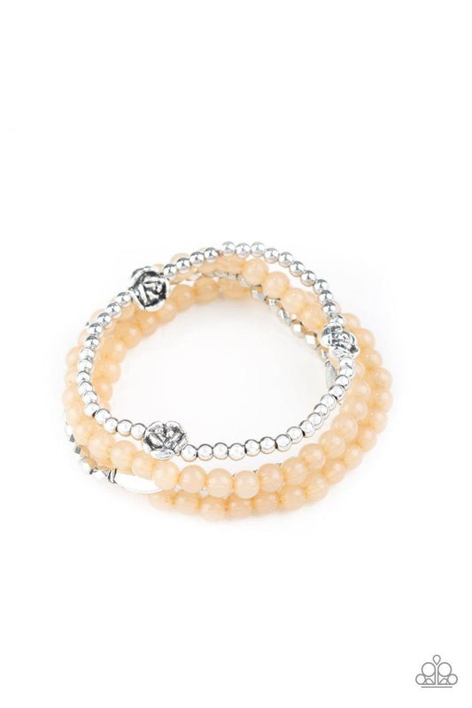 Paparazzi Accessories Blooming Buttercups - Brown Mismatched silver beads and strands of glassy brown beads are threaded along stretchy bands. Infused with silver accents, dainty rose blossoms adorn the wrist for a seasonal finish. Sold as one set of four