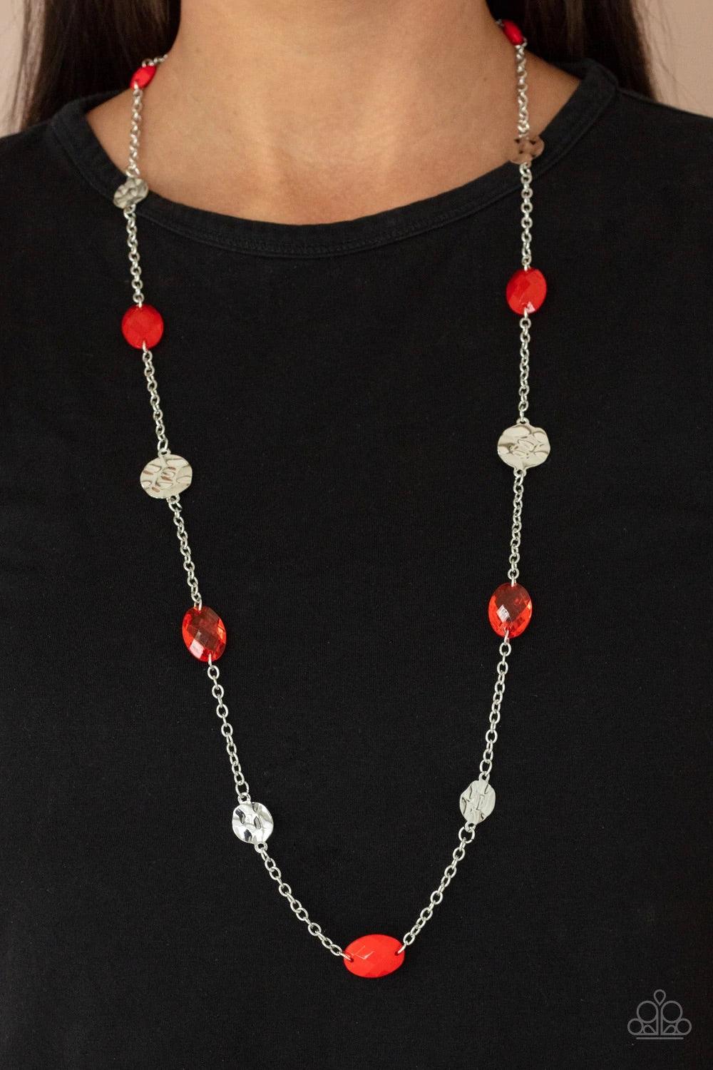 Paparazzi Accessories Glossy Glamorous - Red Featuring glassy, polished, and opaque finishes, a faceted collection of red beads join hammered silver discs along a shiny silver chain, creating a colorful display across the chest. Features an adjustable cla