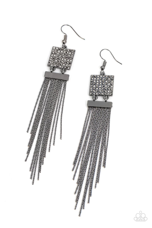Paparazzi Accessories Dramatically Deco - Black A tapered curtain of flat gunmetal chains cascades from a gunmetal rectangular fitting that delicately links to a gunmetal square frame dotted in dainty hematite rhinestones, resulting in a trendy tassel. Ea