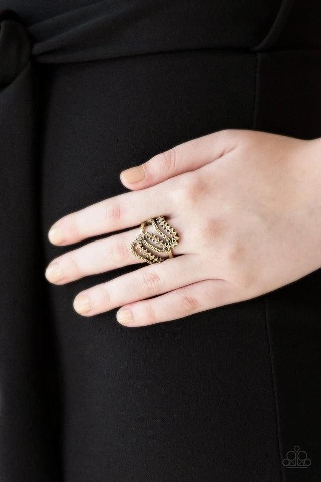 Paparazzi Accessories Make Waves - Brass Encrusted in dainty aurum and golden topaz rhinestones, radiant brass ribbons wave across the finger, coalescing into a whimsical band. Features a stretchy band for a flexible fit. Jewelry