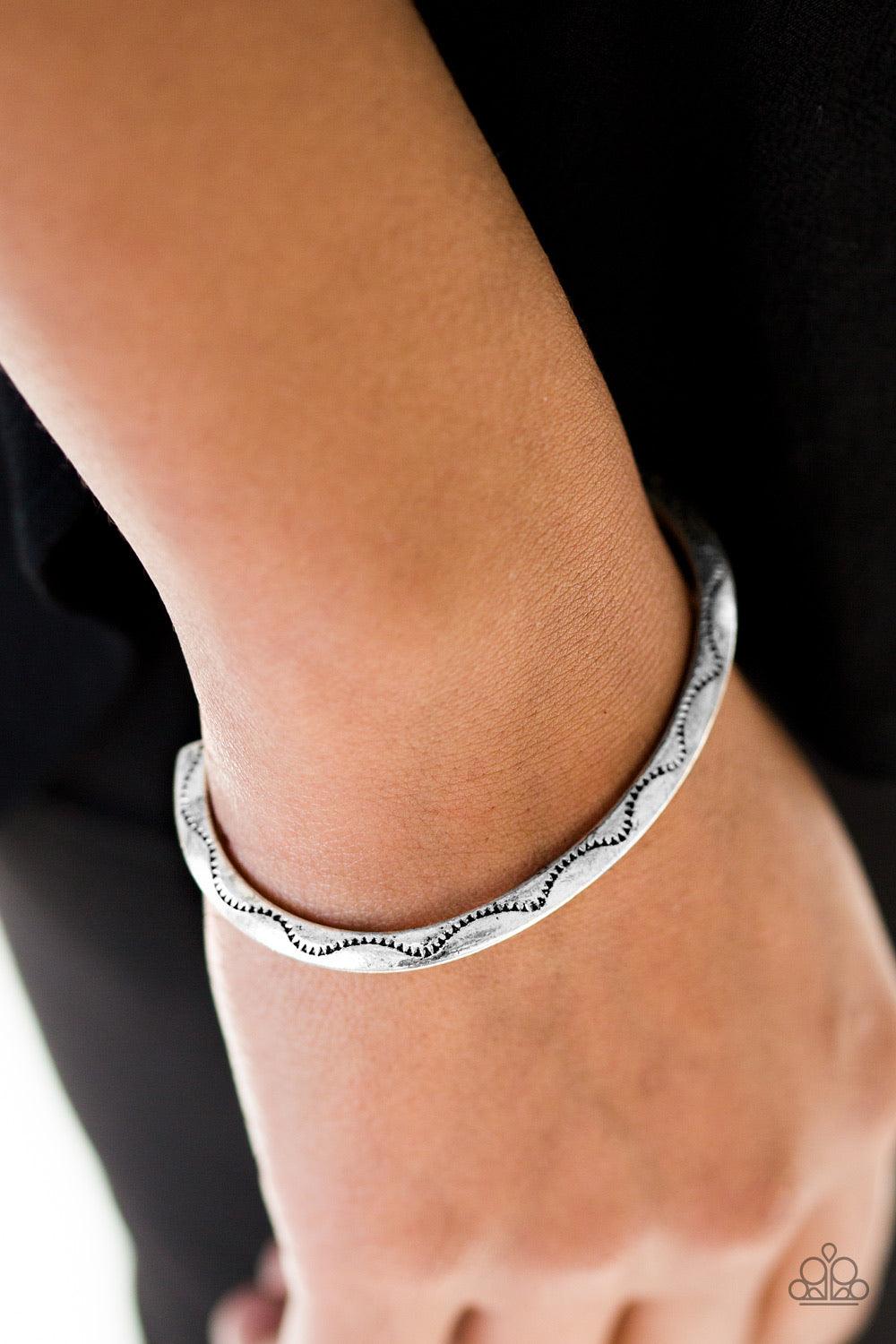 Paparazzi Accessories Desert Charmer - Silver Stamped in a scalloped pattern, a glistening silver cuff wraps around the wrist for a tribal inspired look. Sold as one individual bracelet. Jewelry