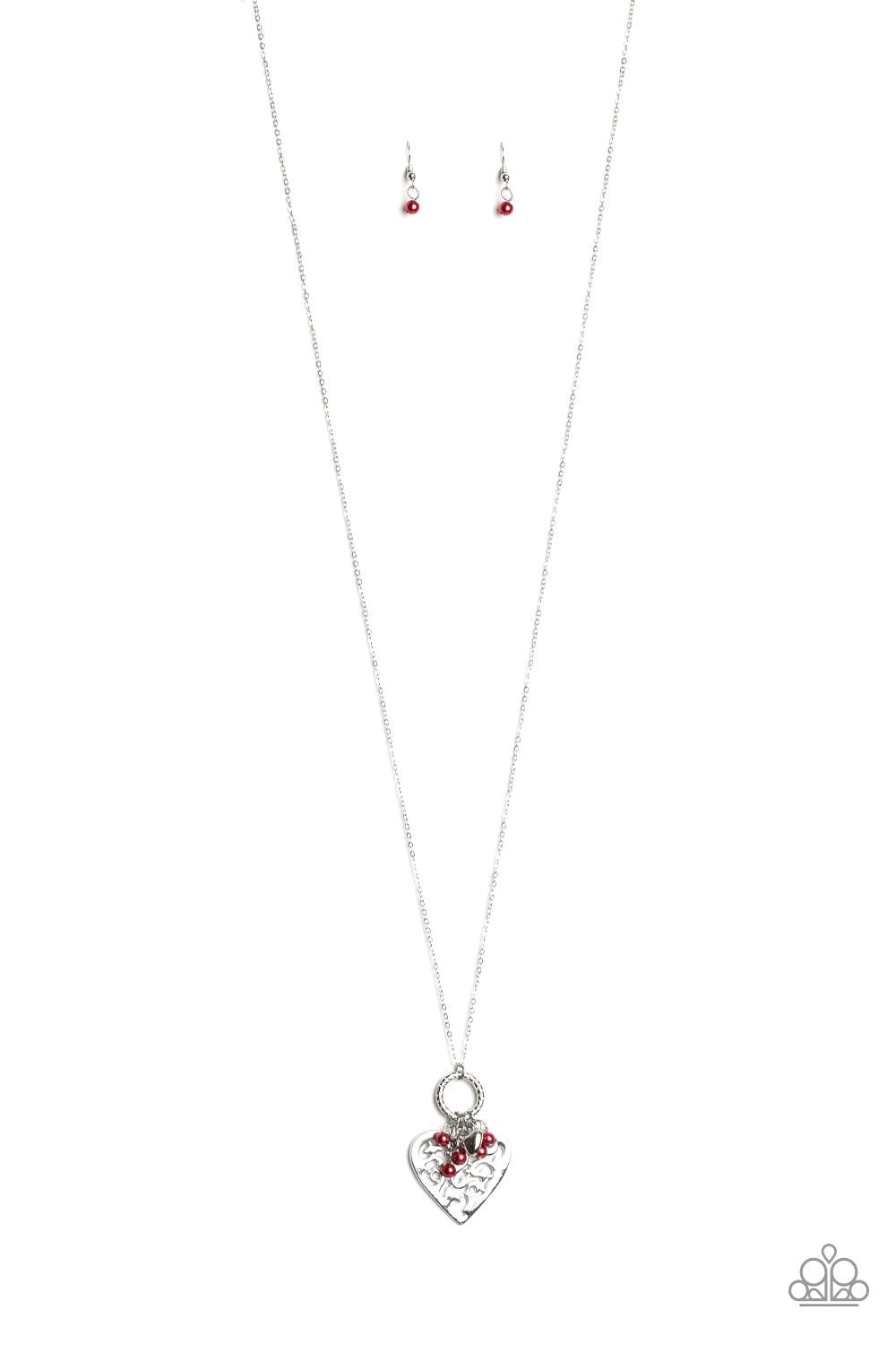 Paparazzi Accessories Romeo Romance - Red Infused with dainty red pearls and a shimmery silver heart charm, a stenciled silver heart pendant swings from the bottom of a lengthened silver chain for a whimsical look. Features an adjustable clasp closure. So