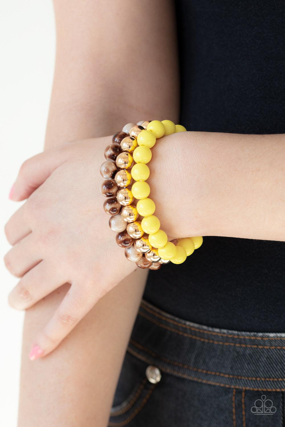 Paparazzi Accessories Courageously Couture - Yellow Strands of yellow, gold, and brown tortoise-like beads are threaded along stretchy bands around the wrist, creating colorful layers. Jewelry
