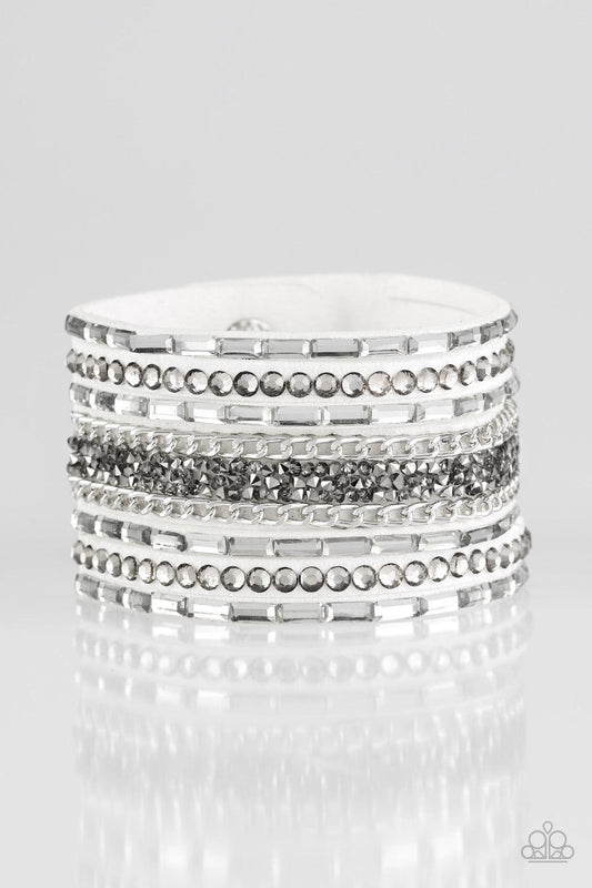 Paparazzi Accessories Rhinestone Rumble - White White emerald-cut rhinestones, smoky round rhinestones, and metallic prism-shaped rhinestones are sprinkled along strands of white suede. Shimmery silver chain is added to the mix for a sassy industrial fini