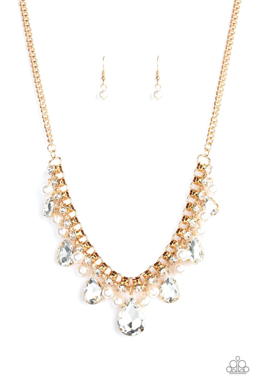 Paparazzi Accessories Knockout Queen - Gold A glamorous collection of bubbly white pearls and exaggerated white teardrop gems dangle from a bold strand of white rhinestones, creating a knockout fringe below the collar. Features an adjustable clasp closure