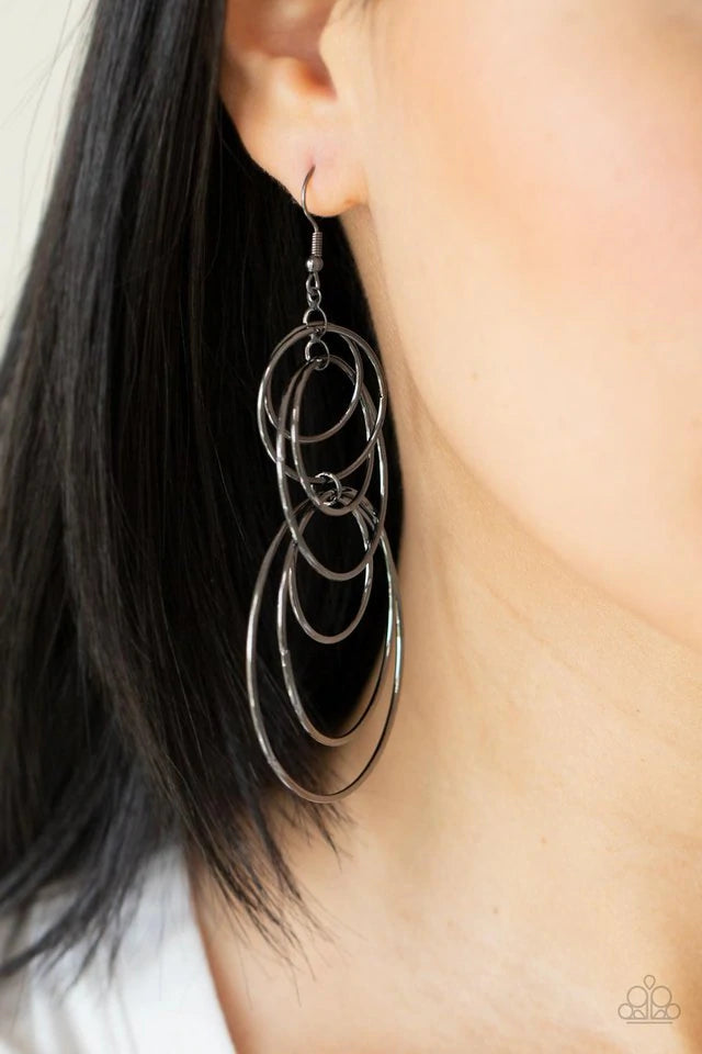 Paparazzi Accessories I Feel Dizzy - Black Varying in size, a shiny collection of mismatched gunmetal hoops haphazardly connect into a dizzying lure. Earring attaches to a standard fishhook fitting. Jewelry