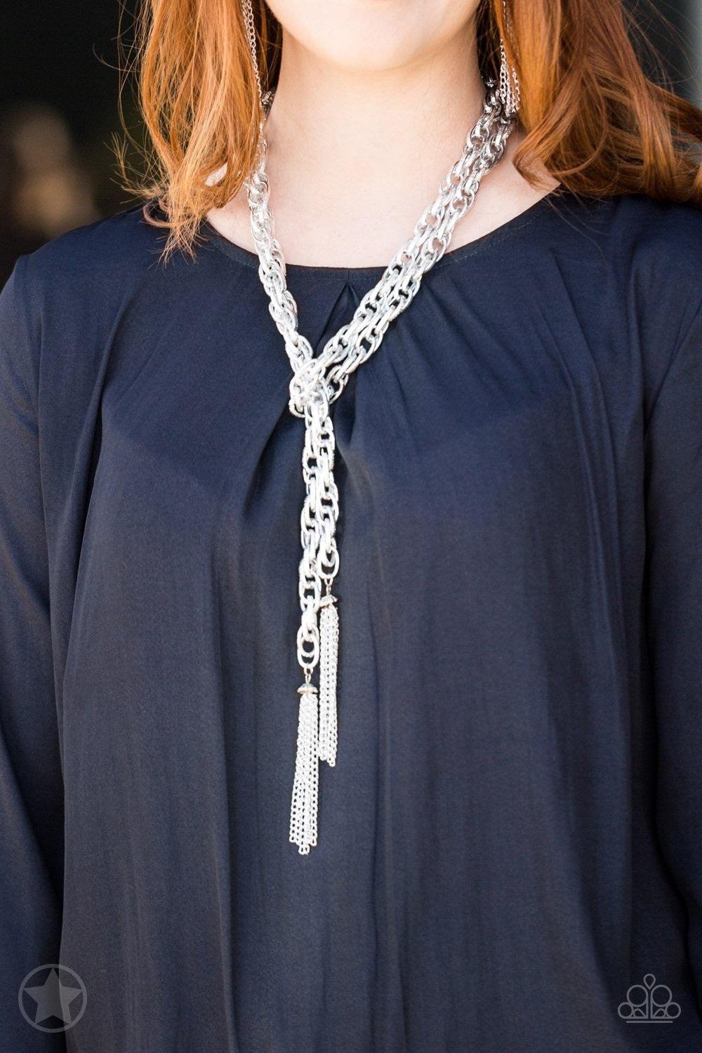Paparazzi Accessories SCARFed for Attention - Silver A single strand of spiraling, interlocking links with light-catching texture is anchored by two tassels of chain that add dramatic length to the piece. Undeniably the most versatile piece in Paparazzi's