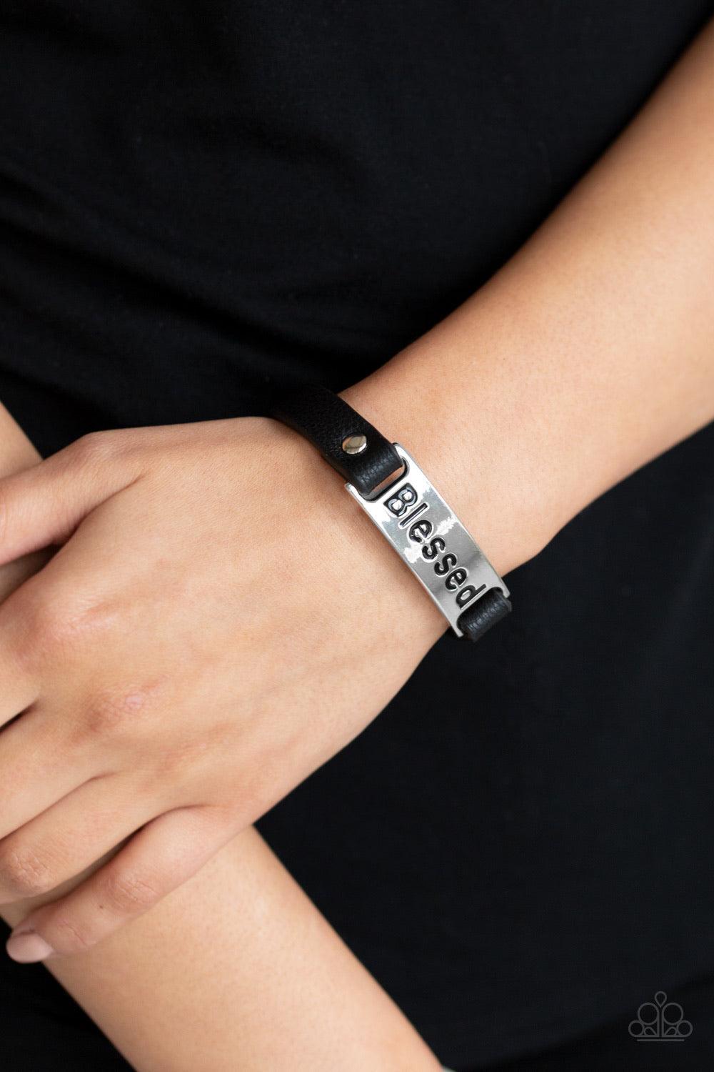 Paparazzi Accessories Count Your Blessings - Black Stamped in the word, "Blessed" a shiny silver plate is studded in place along a dainty black leather band for a whimsical look. Features an adjustable snap closure. Jewelry