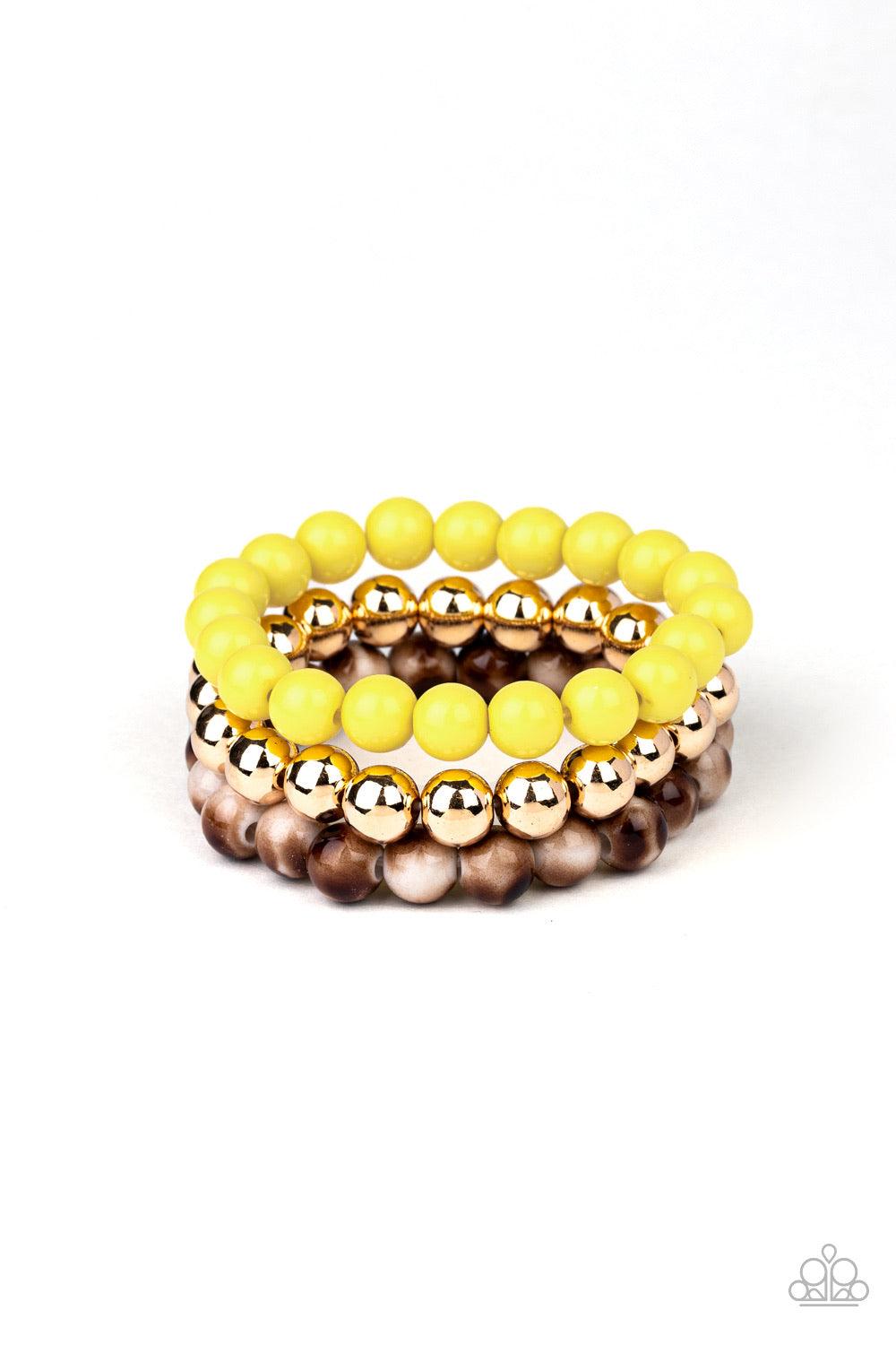 Paparazzi Accessories Courageously Couture - Yellow Strands of yellow, gold, and brown tortoise-like beads are threaded along stretchy bands around the wrist, creating colorful layers. Jewelry