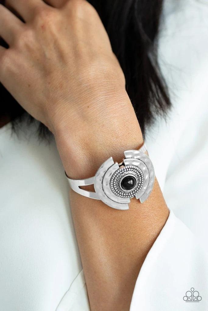 Paparazzi Accessories Incredibly Indie - Black A shiny black bead is pressed into the center of a hammered and studded silver floral frame atop an antiqued cuff for a seasonal look. Sold as one individual bracelet. Jewelry