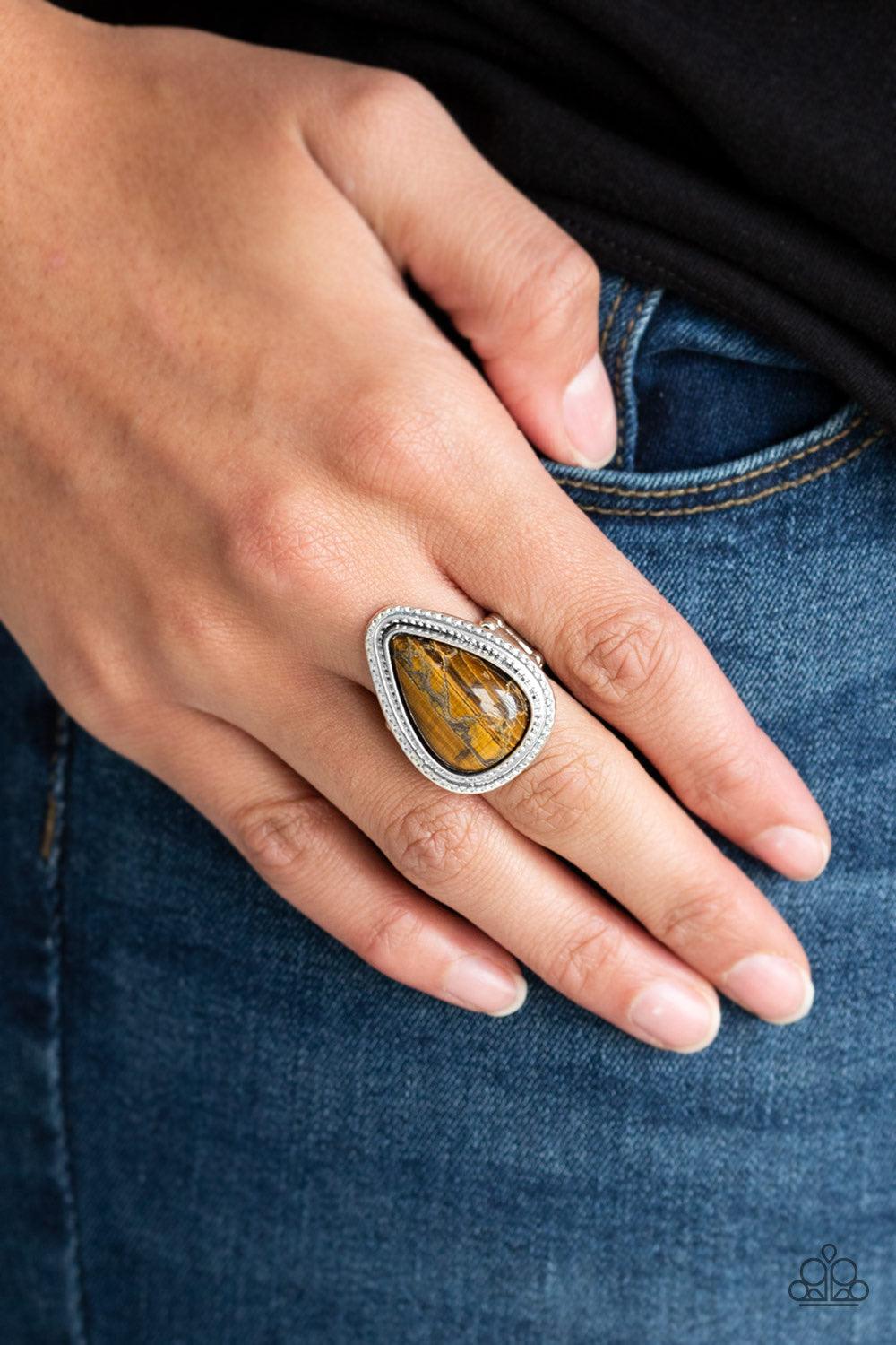 Paparazzi Accessories Mojave Mist - Brown Chiseled into a tranquil teardrop, a rugged Tiger's Eye stone is pressed into a textured silver teardrop frame for a seasonal look. As the stone elements in this piece are natural, some color variation is normal.