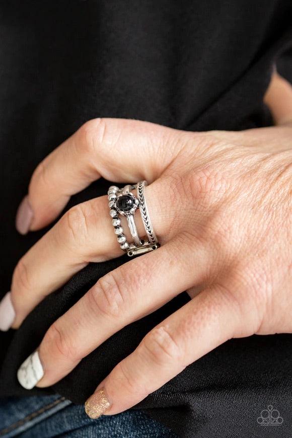Paparazzi Accessories POP Rival - Black A trio of studded, smooth, and tribal stamped silver bands layer across the finger, coalescing into an airy frame. A shiny black bead is pressed into the center of the shimmery layers for a perfect pop of color. Fea