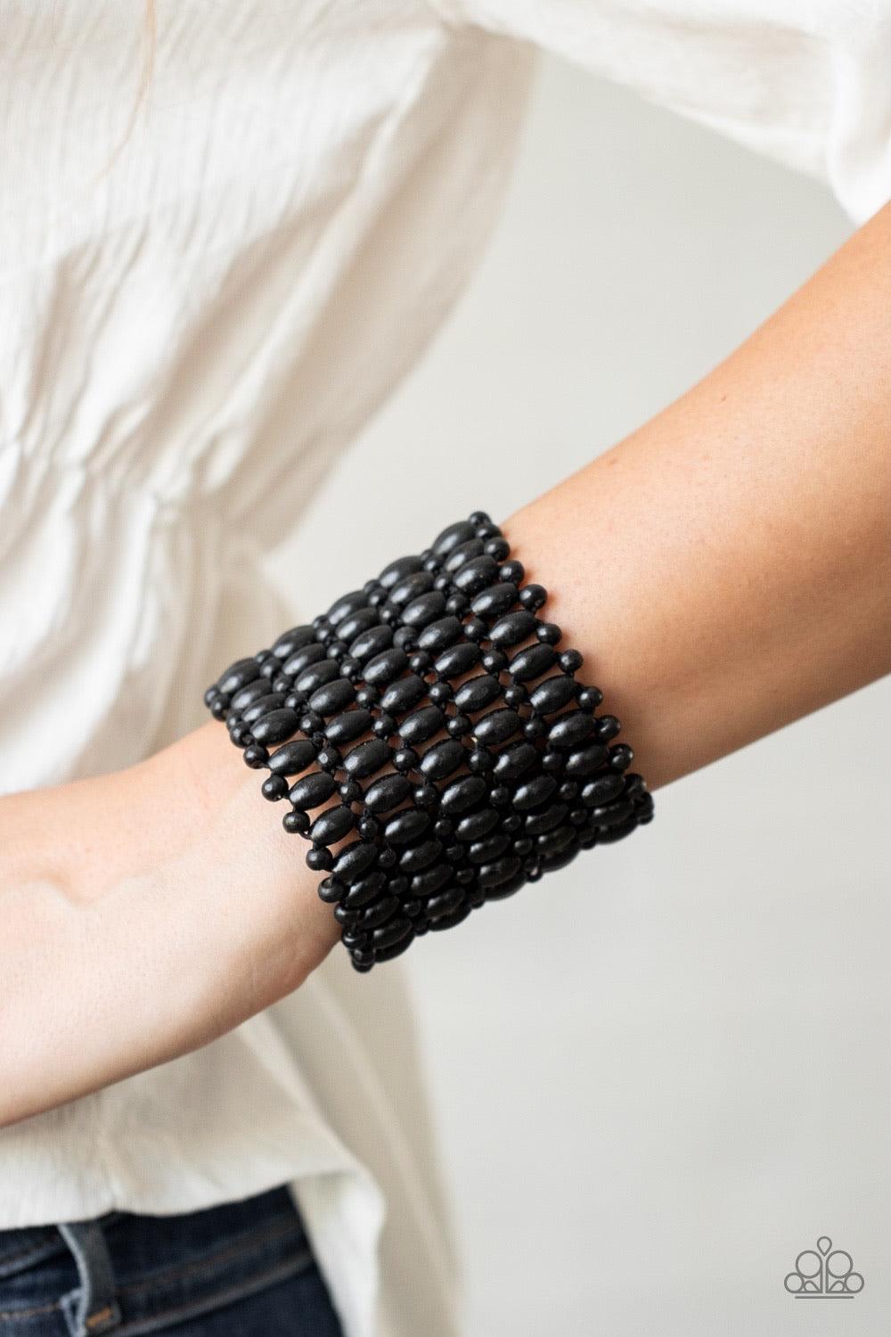 Paparazzi Accessories Way Down In Kokomo ~Black Round and oval black wooden beads are threaded along stretchy bands that intricately weave around the wrist, coalescing into a colorful stretch bracelet. Sold as one individual bracelet.