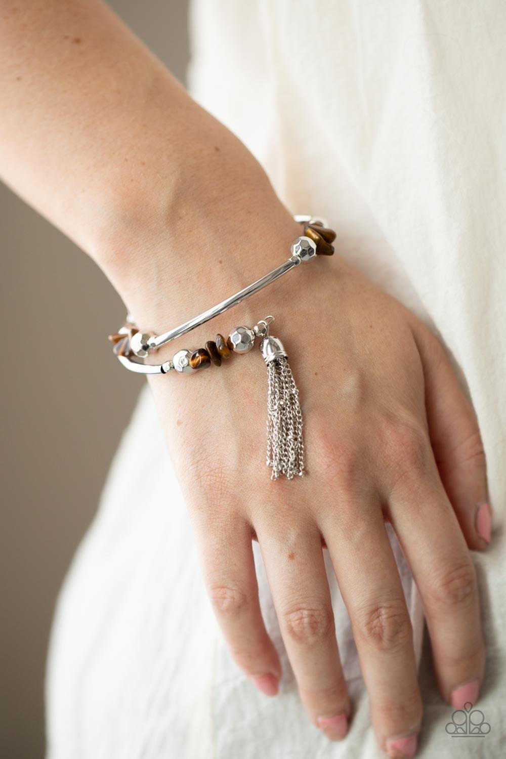 Paparazzi Accessories Mineral Mosaic - Brown An earthy collection of faceted silver beads, raw cut tiger's eye rock beads, and cylindrical silver accents are threaded along a coiled wire around the wrist for a grounding pop of color. A shimmery silver cha