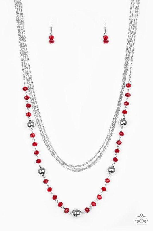 Paparazzi Accessories High Standards - Red Infused with rows of shimmery silver chains, a strand of glittery red crystal-like beads and classic silver accents drape across the chest for a regal finish. Features an adjustable clasp closure. Sold as one ind