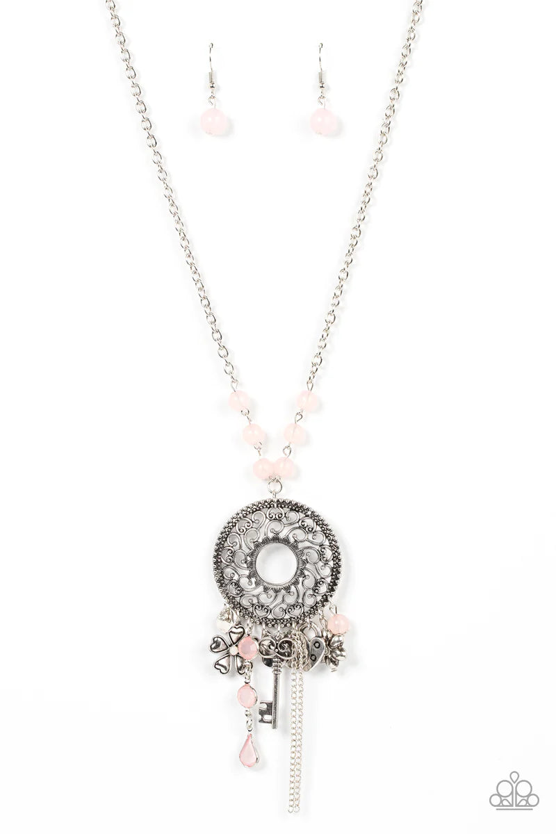 Paparazzi Accessories Making Memories - Pink Infused with glassy Pale Rosette beaded accents, a whimsical assortment of silver key, heart, and floral charms cascades from an oversized studded silver frame that whirls with heart shaped vine-like filigree.