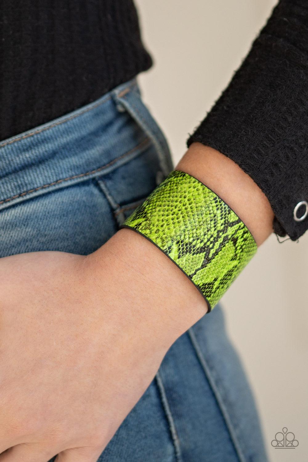 Paparazzi Accessories It’s a Jungle Out There - Green Featuring neon green python print, a thick leather band wraps around the wrist for a colorfully wild look. Features an adjustable snap closure. Jewelry