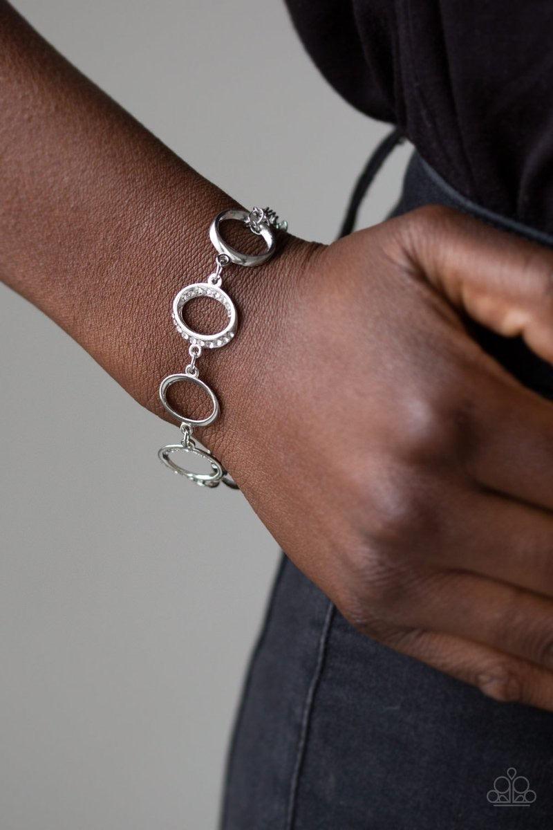 Paparazzi Accessories Beautiful Inside and Out - White Glistening silver hoops link with white rhinestone encrusted hoops around the wrist for a timeless shine. Features an adjustable clasp closure. Jewelry