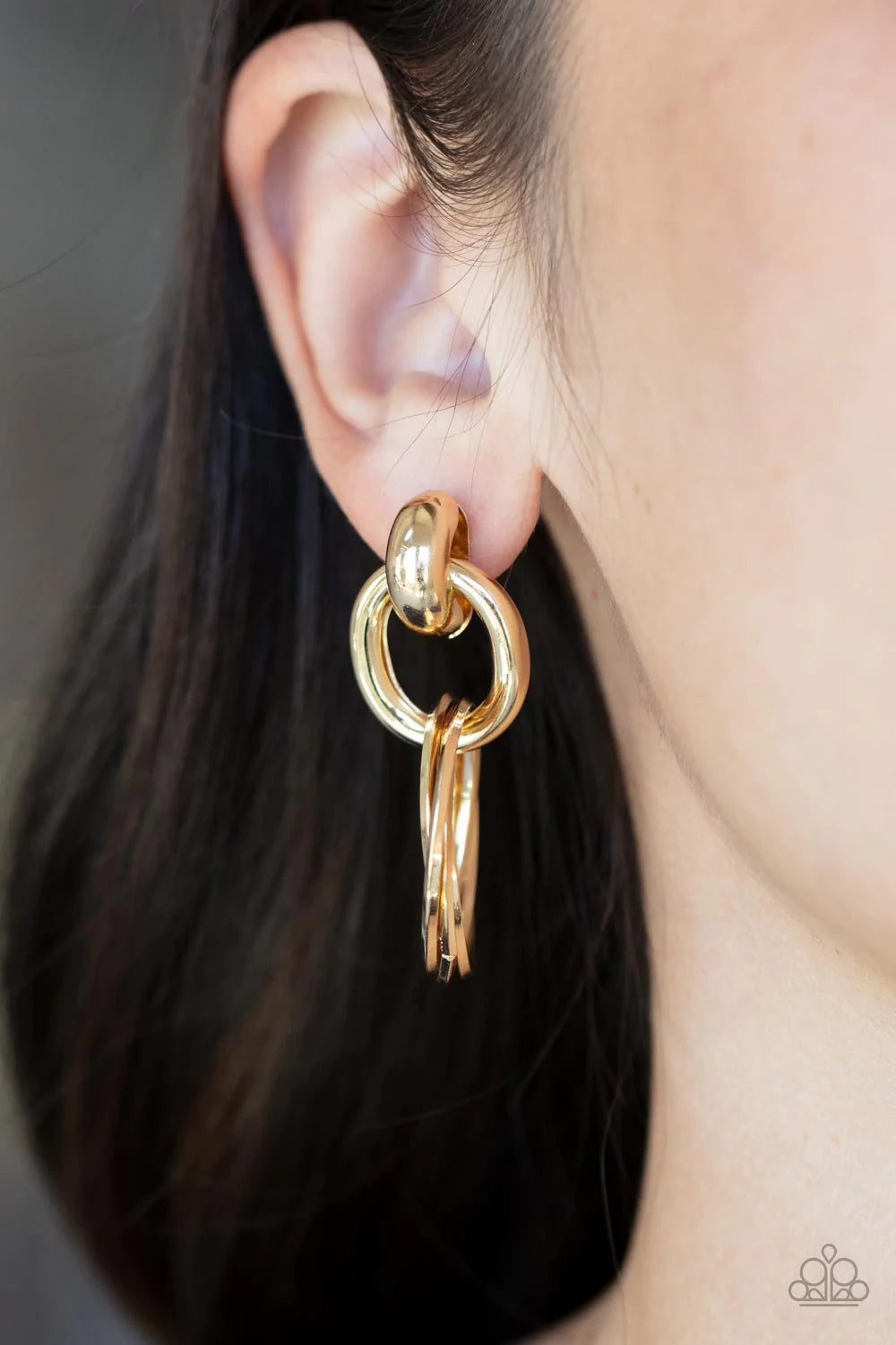 Paparazzi Accessories Dynamically Linked Glistening gold hoops are threaded through a bold gold fitting, adding a timeless twist to the dynamic display. Earring attaches to a standard post fitting. Sold as one pair of post earrings.