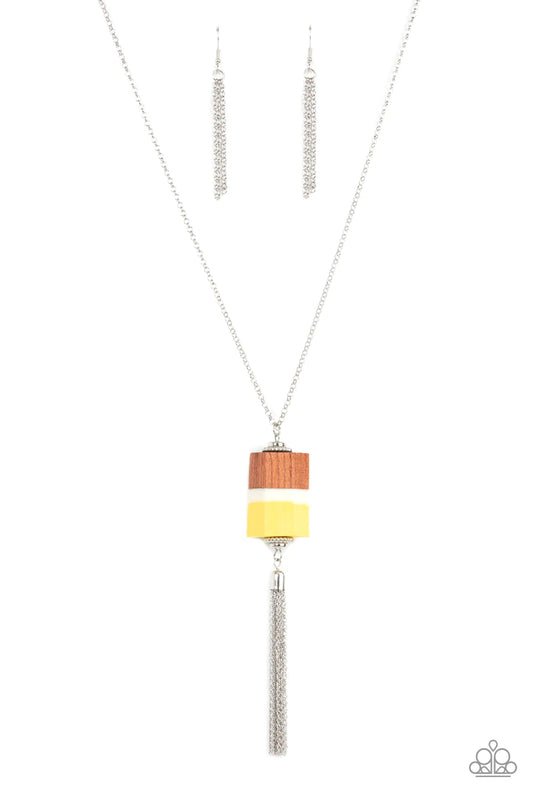 Paparazzi Accessories Reel It In - Yellow Infused with silver beaded accents, pieces of yellow and brown wood and a white acrylic accent delicately stack into a faceted geometric pendant at the bottom of an extended silver chain. A shimmery silver chain t