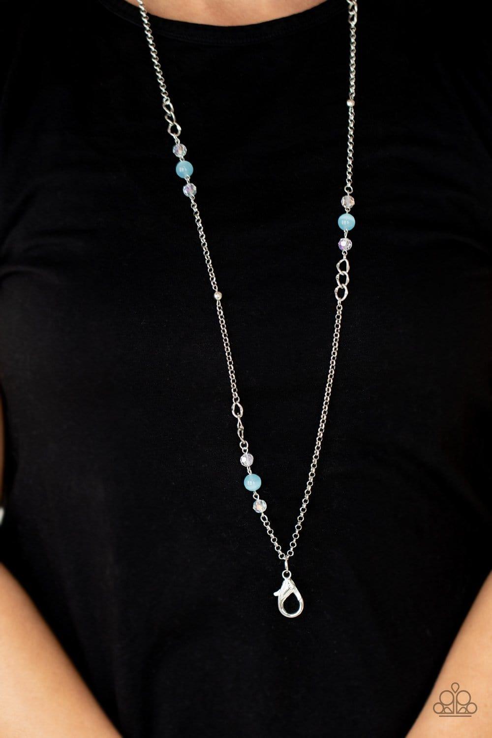 Paparazzi Accessories Teasingly Trendy - Blue *Lanyard Infused with dainty silver beads, rows of iridescent crystal-like accents and glowing Cerulean cat's eye stone beads adorn sections of mismatched silver chain across the chest for a trendy pop of colo