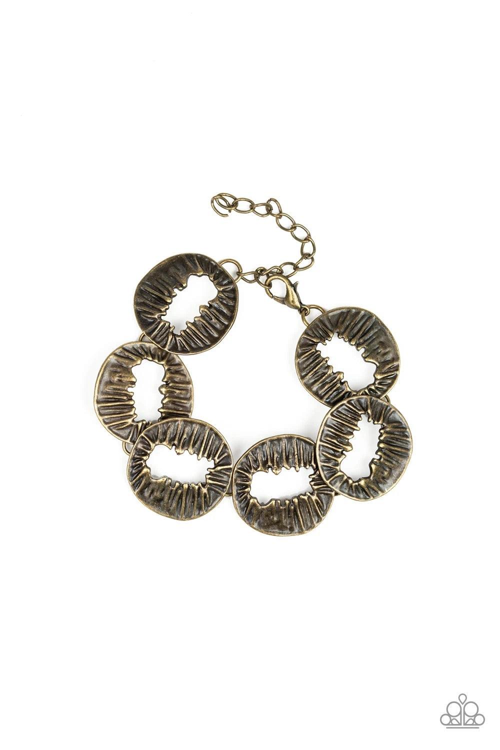 Paparazzi Accessories Cut It Out! - Brass Featuring asymmetrical cutout centers, textured brass discs connect across the wrist for an abstract look. Features an adjustable clasp closure. Sold as one individual bracelet. Jewelry