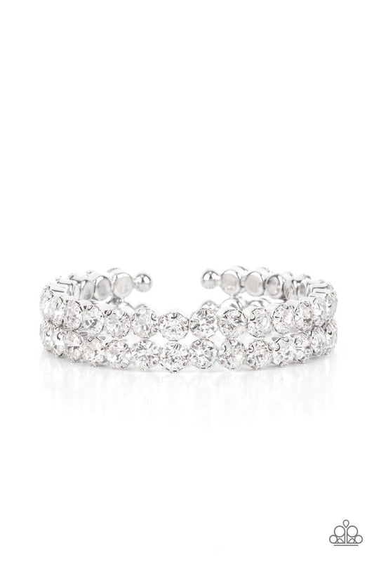 Paparazzi Accessories Megawatt Majesty - White Encased in sleek silver fittings, two oversized rows of glassy white rhinestones stack into a blinding cuff around the wrist for a jaw-dropping look. Sold as one individual bracelet. Jewelry