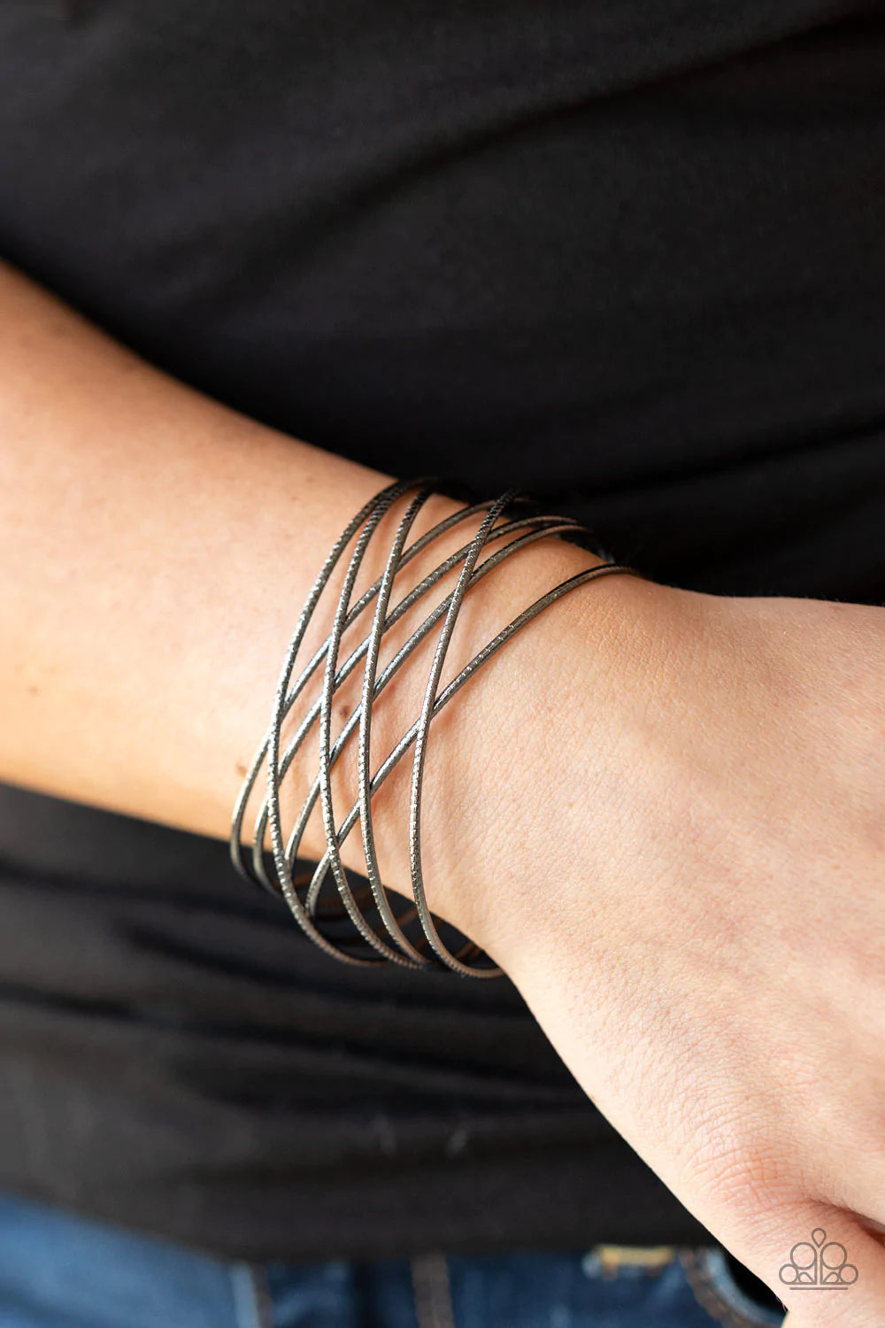 Paparazzi Accessories Strike Out Shimmer - Black Etched in diamond cut texture, shimmery gunmetal bars crisscross across the wrist, resulting in an edgy layered cuff. Sold as one individual bracelet. Bracelets