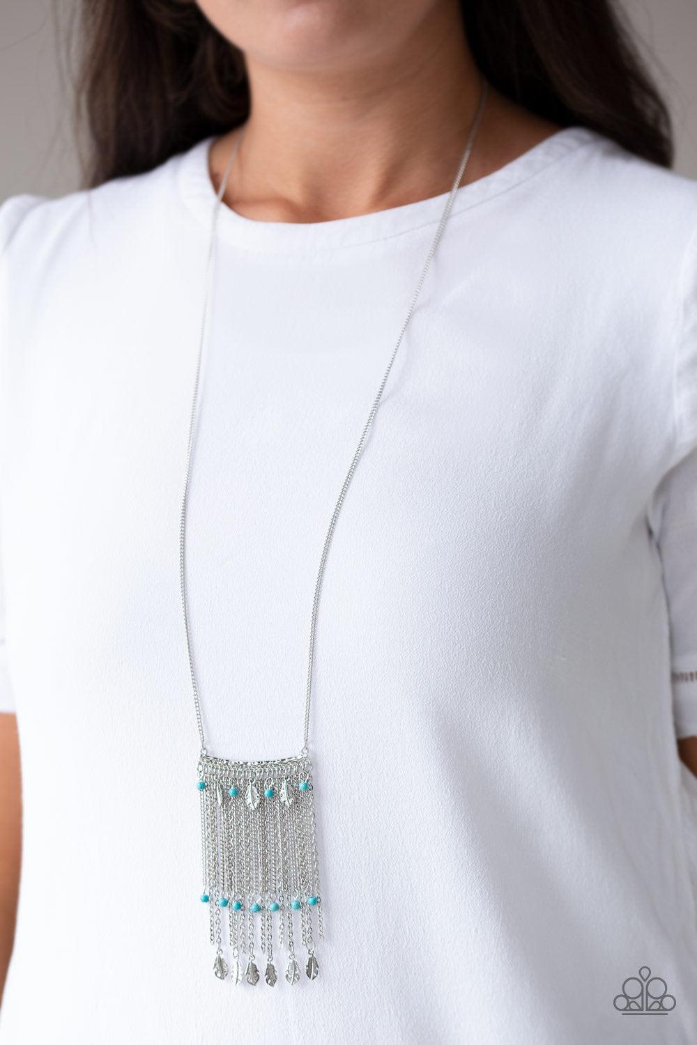 Paparazzi Accessories On The Fly - Blue Attached to a lengthened silver chain, a hammered silver bar gives way to a fringe of shimmery silver chain, dainty turquoise stone beads, and silver feather frames for a seasonal look. Features an adjustable clasp