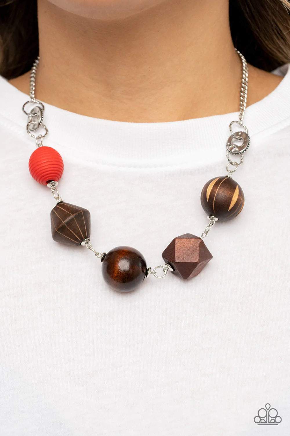 Paparazzi Accessories Eco Extravaganza - Red Infused with a solitaire red wooden bead, a mismatched assortment of studded silver hoops, textured silver rings, and oversized brown wooden beads delicately connect across the chest for a stylishly handcrafted