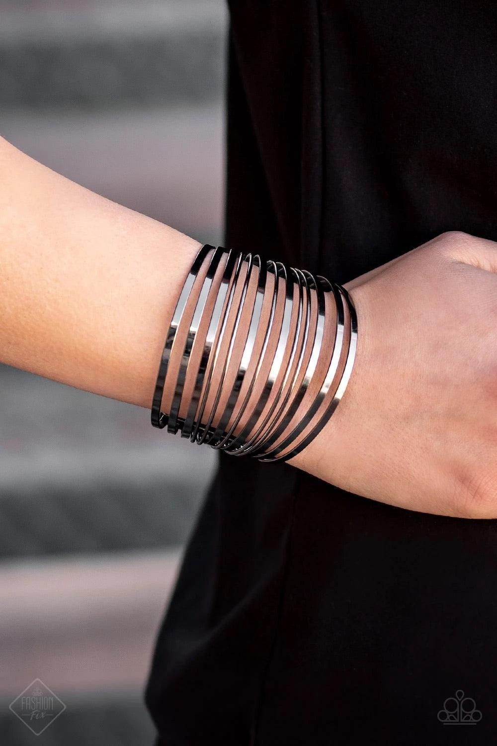 Paparazzi Accessories Front Line Shine ~Black Row after row of flat gunmetal and dainty gunmetal bars arc across the wrist, coalescing into a stacked cuff that demands attention. Sold as one individual bracelet.