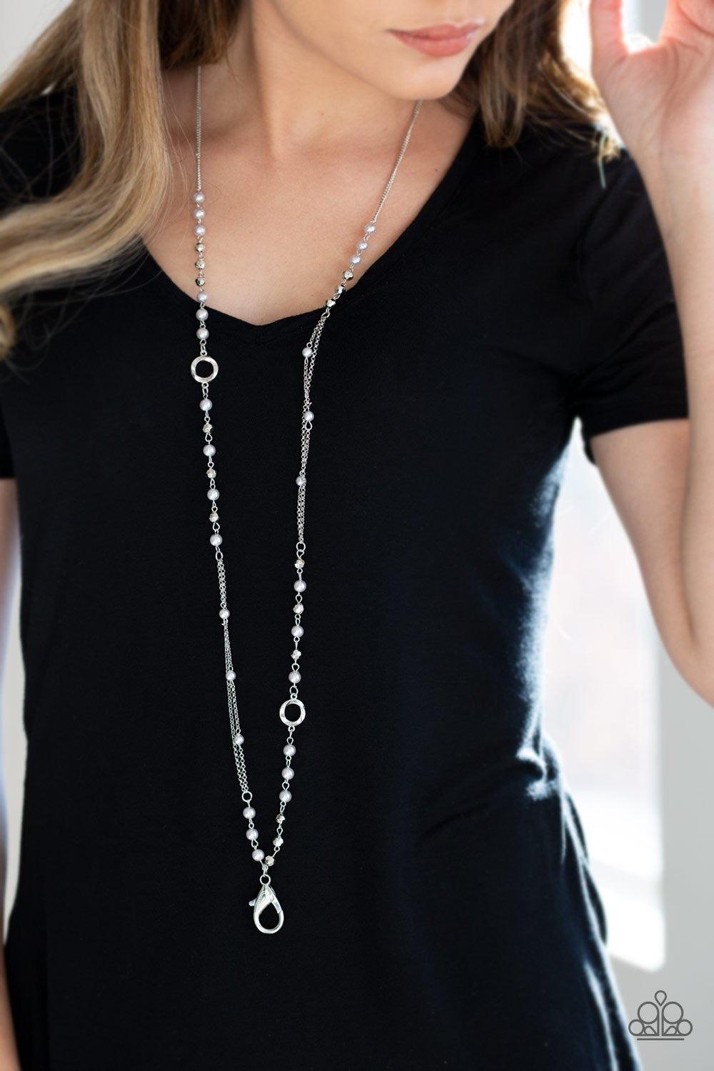 Paparazzi Accessories Really Refined - Silver *Lanyard A collection of pearly silver, twisting silver hoops, and faceted silver beads trickle along an asymmetrical silver chain for a refined look. A lobster clasp hangs from the bottom of the design to all