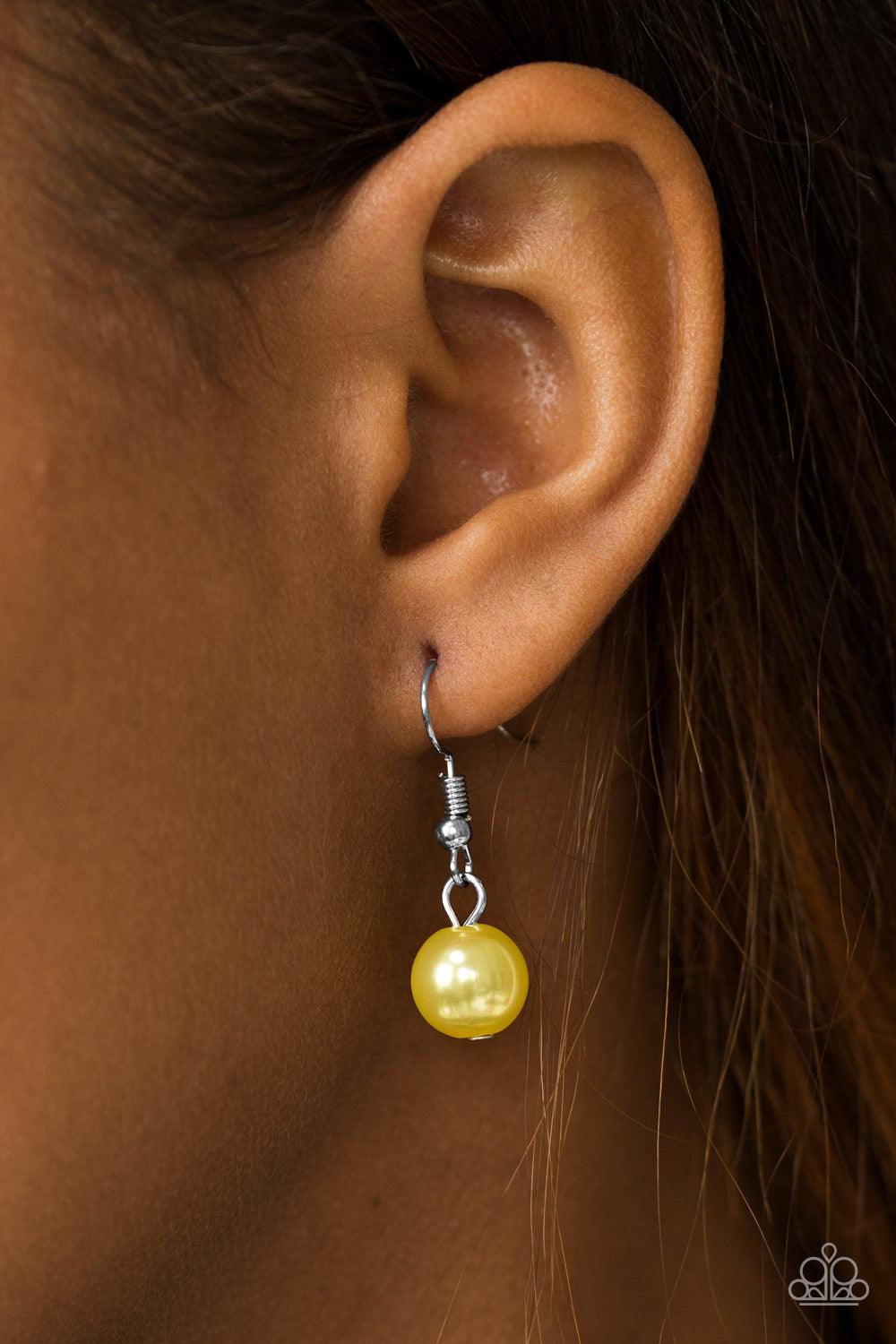 Paparazzi Accessories Run The Show - Yellow Classic yellow pearls trickle from the bottom of a glistening silver chain. Shimmery silver hoops cascade from the pearls, creating a flirty fringe below the collar. Features an adjustable clasp closure. Jewelry