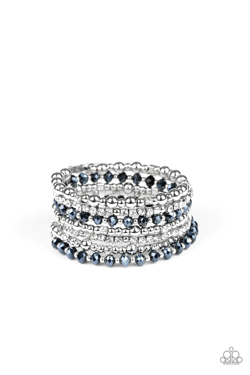 Paparazzi Accessories Ice Knowing You - Blue An icy collection of silver beads, silver cubes, metallic blue crystals, and glassy white rhinestones are threaded along a coiled wire, creating a blinding infinity wrap style bracelet around the wrist. Sold as