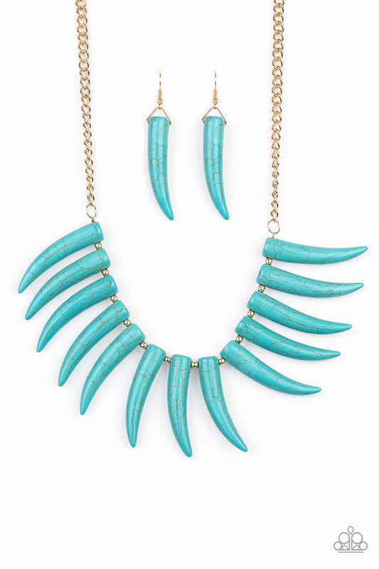 Paparazzi Accessories Tusk Tundra - Blue Infused with dainty gold beads, tusk-shaped turquoise stone beads are threaded along an invisible wire below the collar, creating a wild fringe. Features an adjustable clasp closure. Sold as one individual necklace
