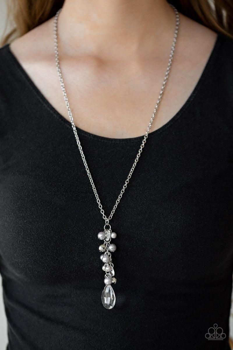 Paparazzi Accessories Teardrop Serenity - Silver A collection of gray pearls, shiny silver beads, and glassy white teardrops trickle along an extended chain that swings from the bottom of a classic silver chain. An over sized teardrop swings from the bott